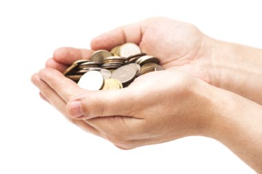 Handful of coins in palm hands isolated on white clipart