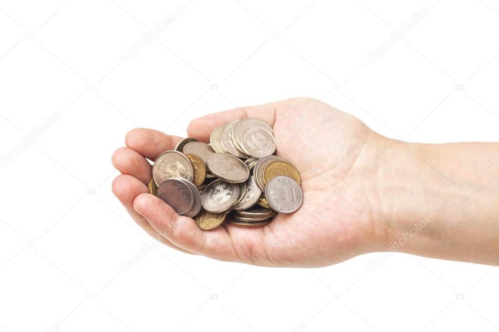 Handful of coins in palm hand isolated on white