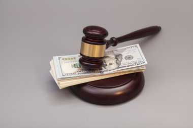 Bir yığın üzerinde gri izole dolar üzerinde hukuk tokmak