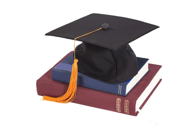 毕业帽上的粘的书 — 图库照片