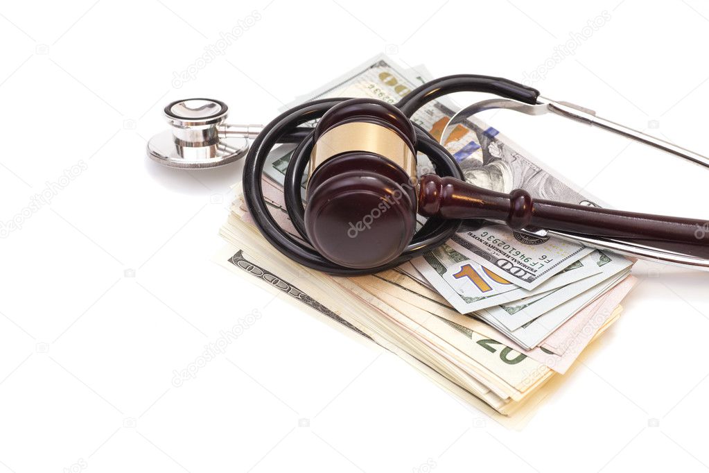 Stethoscope with judge gavel and dollar banknotes isolated on wh