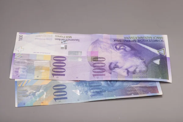 Švýcarských franků, měna Švýcarska izolované na šedé — Stock fotografie