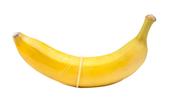 Банан з презервативом ізольований на білому — стокове фото