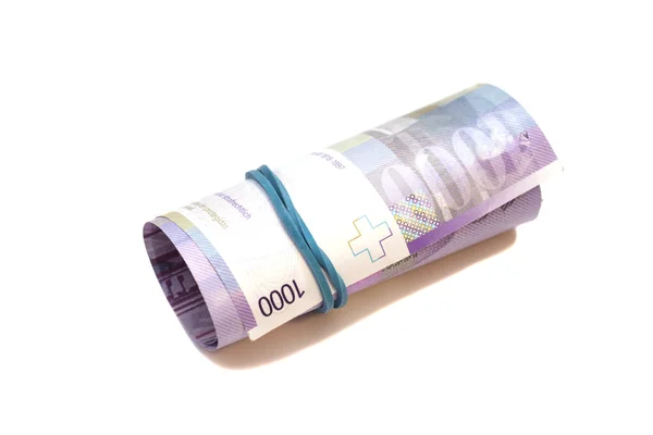 Mil francos suizos en rollo sobre fondo blanco — Foto de Stock