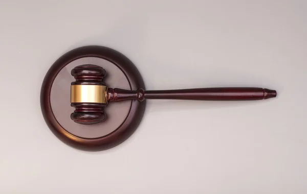 Wooden judge gavel and soundboard on  grey background — Stock Photo, Image