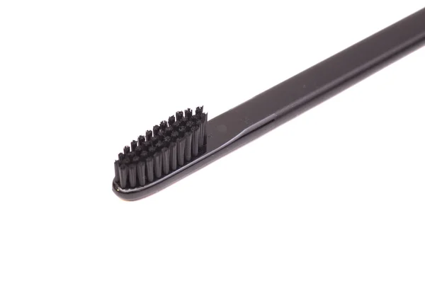 Schwarze Zahnbürste auf weißem Hintergrund — Stockfoto