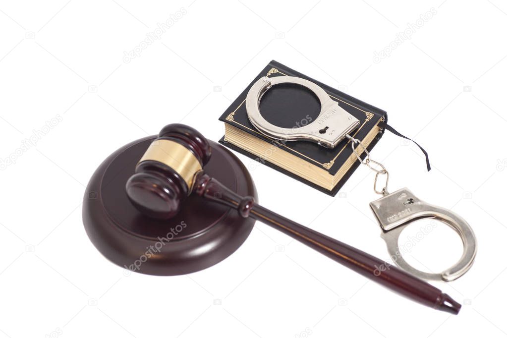 Judge gavel,Handcuffs and book on law isolated on white backgrou