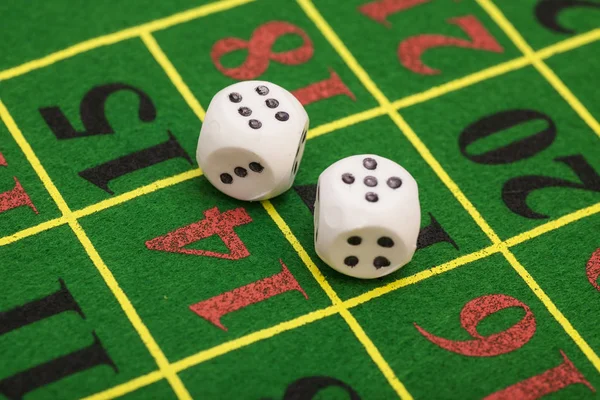 roll of the white dice on game table in a casino