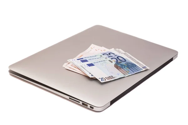 Laptop met Euro geld geïsoleerd op wit — Stockfoto