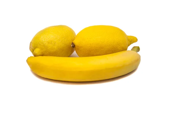 Банан и два лимона — стоковое фото