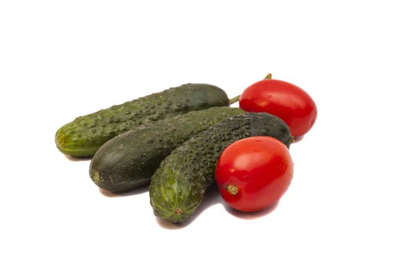 Tomatoes and green cucumbers — Stock Photo, Image