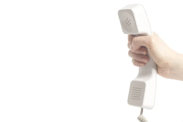 Mão segurando tubo de telefone branco — Fotografia de Stock