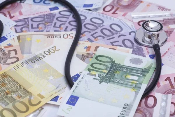 Euro banknotes and stethoscope close up