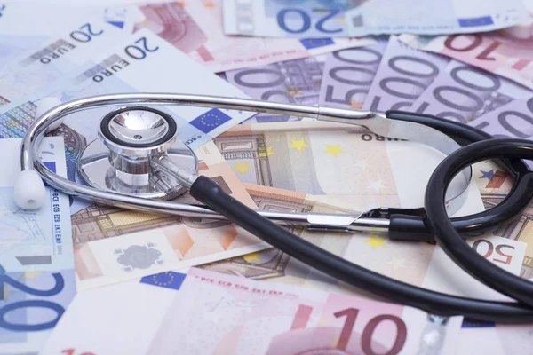 Euro banknotes and stethoscope close up