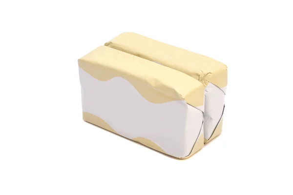 Paus de manteiga embrulhados isolados sobre um fundo branco — Fotografia de Stock