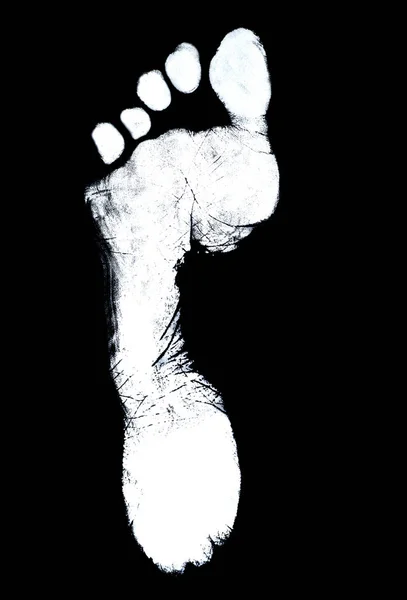 Human foot print on black background