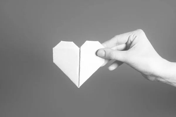 Paper origami Valentines Day heart in hand. — Stock Photo, Image