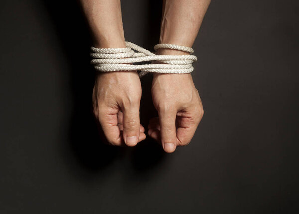 Male hands bound with rope.addiction concept.