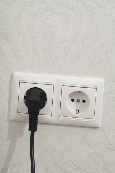 White electric socket with plug on the wall — Stock Photo, Image