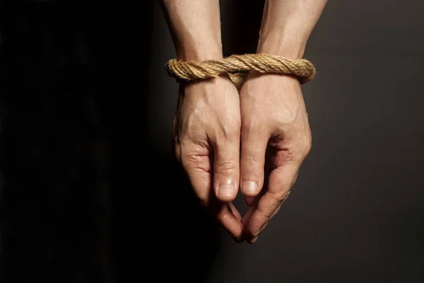 Male hands bound with rope. Addiction concept. — Stock Photo, Image