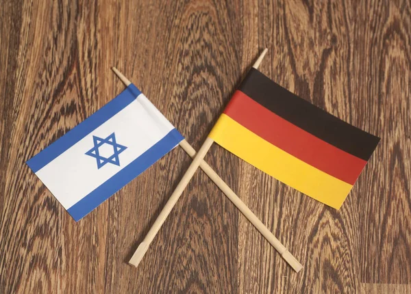 Germany end Israel Flag on wooden background