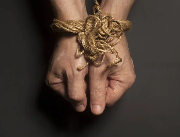 Male hands bound with rope — Stock Photo, Image