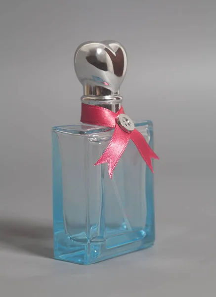 Woman perfume in bottles with ribbon