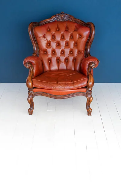 Vintage leather Luxury brown armchair Classic Brown leather sofa and old blue background.