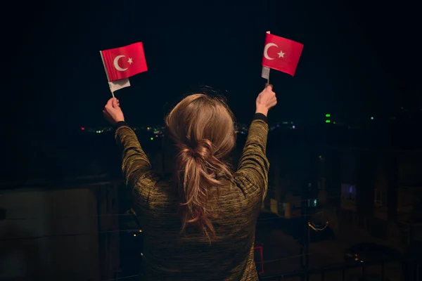 Turkish Woman Holding, Waving 2 Turkish Flags at night Celebrating April 23 National Sovereignty Children\'s Day