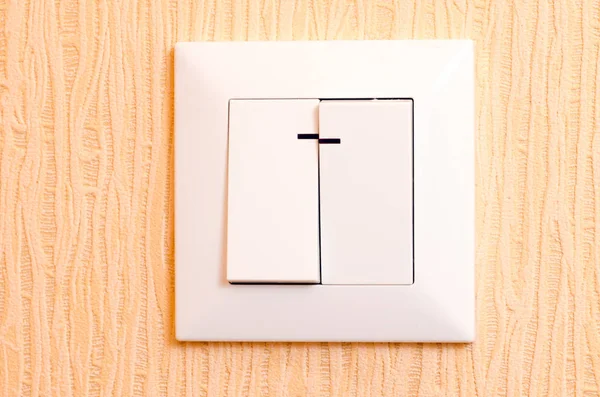 White light switch on yellow background wallpaper