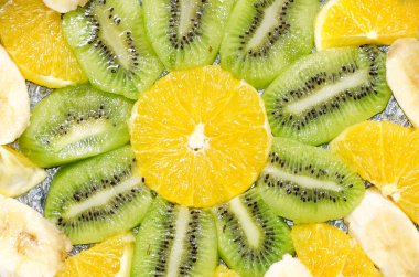 kivi, portakal ve muz şeffaf olarak dilimler halinde dilimlenmiş