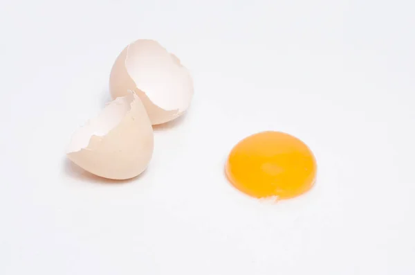 Eggs chicken bird with egg yolk and shell on a gray background — Stock Photo, Image
