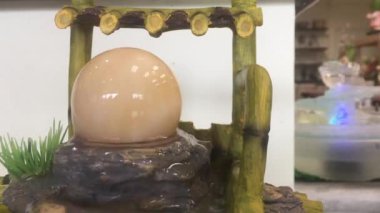 Fountain. Rotating stone sphere in bowl