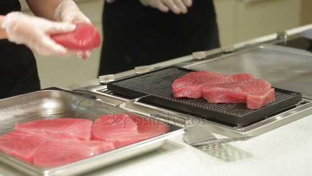 Chef hands take fillets tuna on grill — Stock Video