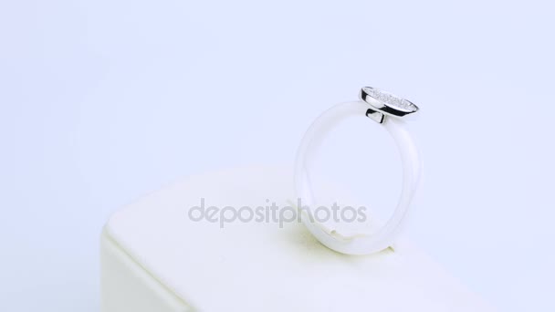 A white ring is with small diamonds on white background — Stock Video