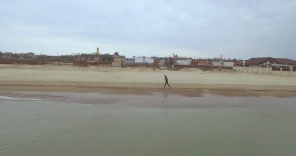 Aerial view, a sport man running on the beach Odessa, Ukraine — Stock Video