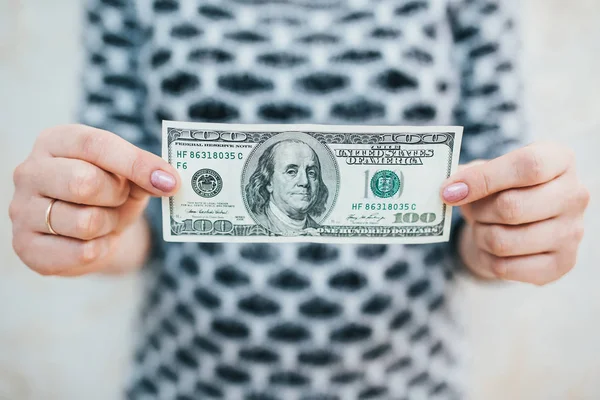 A young woman with dollars in her hands. Isolated on white background — Stock Photo, Image