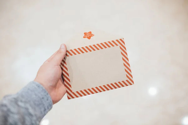A man presents a gift Christmas envelope