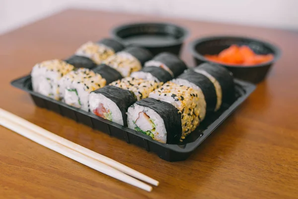 The sushi on the table in the delivery package, ordered in sushi roll