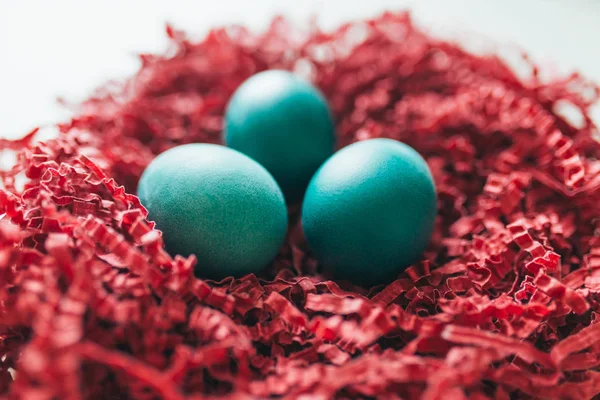 Easter eggs on wooden background in nest — Stock Photo, Image