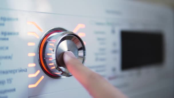Uma mão ligando e desligando o interruptor de uma máquina de lavar — Vídeo de Stock