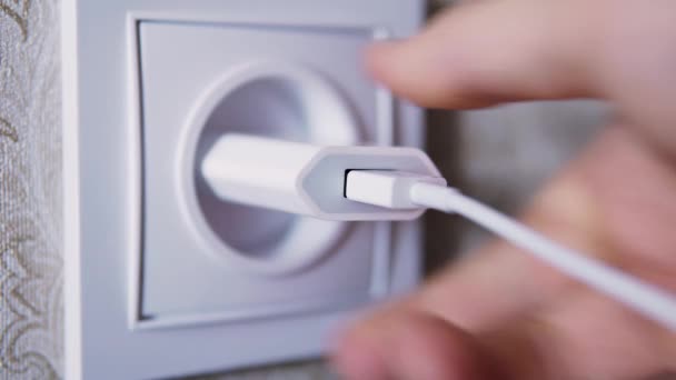 Man hand plug in charger adapter into wall socket close up — 비디오