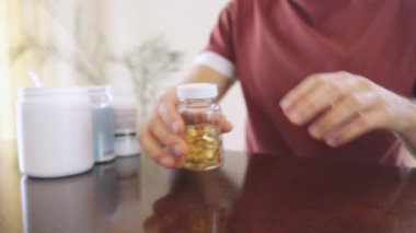 Vitamins and supplements. Man takes omega 3 capsules of vitamins or medicine