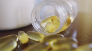 Capsules omega 3 close up on the table dolly shot using shallow depth of field