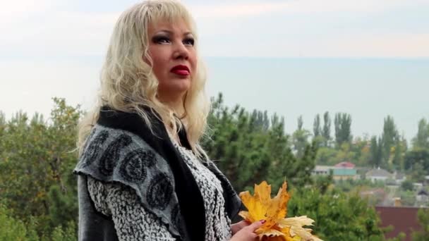 Woman is Standing and Looking at the Sea From Afar, and Turns Her Head — Stock Video