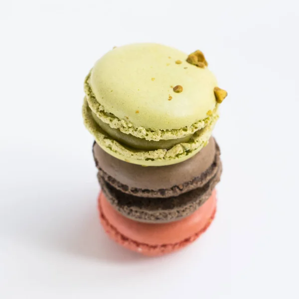 French colorful macarons. Three desserts isolated close up photo.