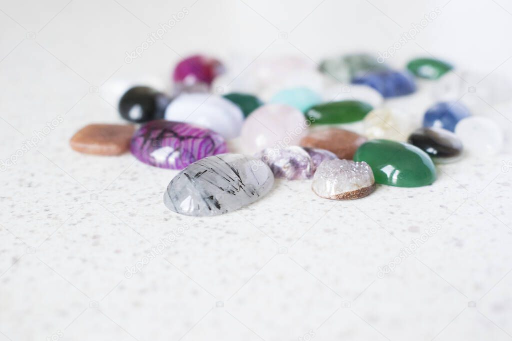 Multicolored polished stones for making jewellery. Colorful cabochons for jeweller.