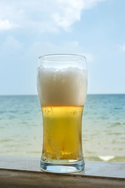 Glass of cold beer with foam Royalty Free Stock Images