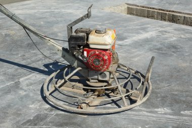 Power trowel machine on a construction site clipart