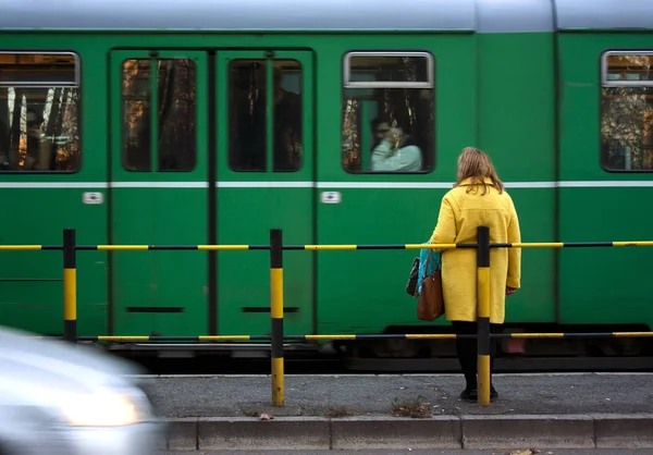 Woman at a tram stop — Stock Photo, Image